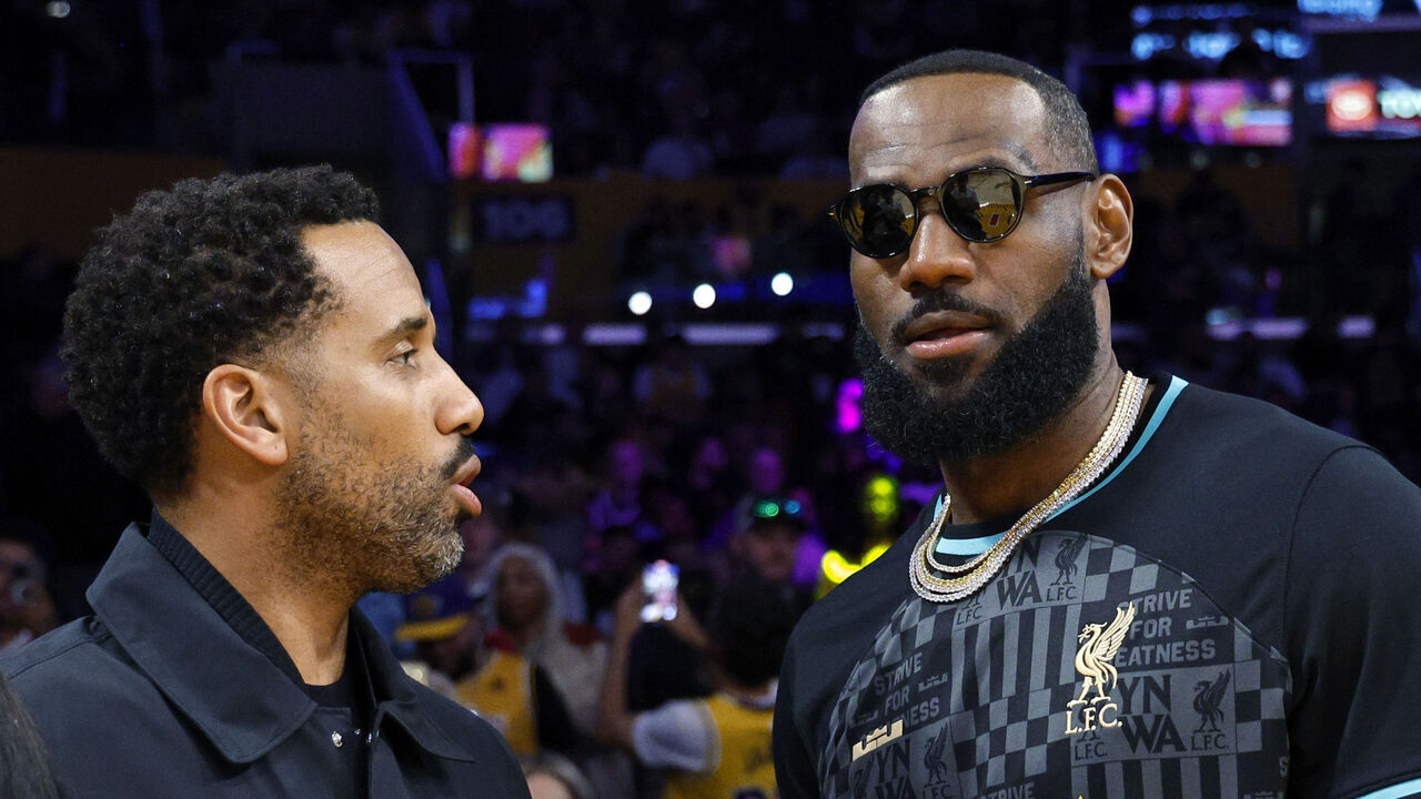 LOS ANGELES, CALIFORNIA - MARCH 8: LeBron James #23 of the Los Angeles Lakers wearing a Liverpool FC jersey and Maverick Carter attends the game between Los Angeles Lakers and Milwaukee Bucks at Crypto.com Arena on March 8, 2024 in Los Angeles, California.
