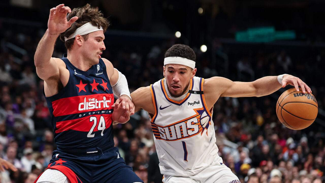 WASHINGTON, DC - JANUARY 16: Devin Booker #1 of the Phoenix Suns goes to the basket against Corey Kispert #24 of the Washington Wizards during the first half at Capital One Arena on January 16, 2025 in Washington, DC.