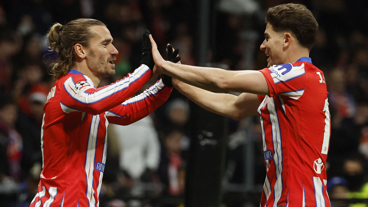 TOPSHOT - Atletico Madrid's French forward #07 Antoine Griezmann celebrates with Atletico Madrid's Argentine forward #19 Julian Alvarez scoring his team's third goal during the UEFA Champions League, league phase football match between Club Atletico de Madrid and Slovan Bratislava at the Metropolitano stadium in Madrid on December 11, 2024.