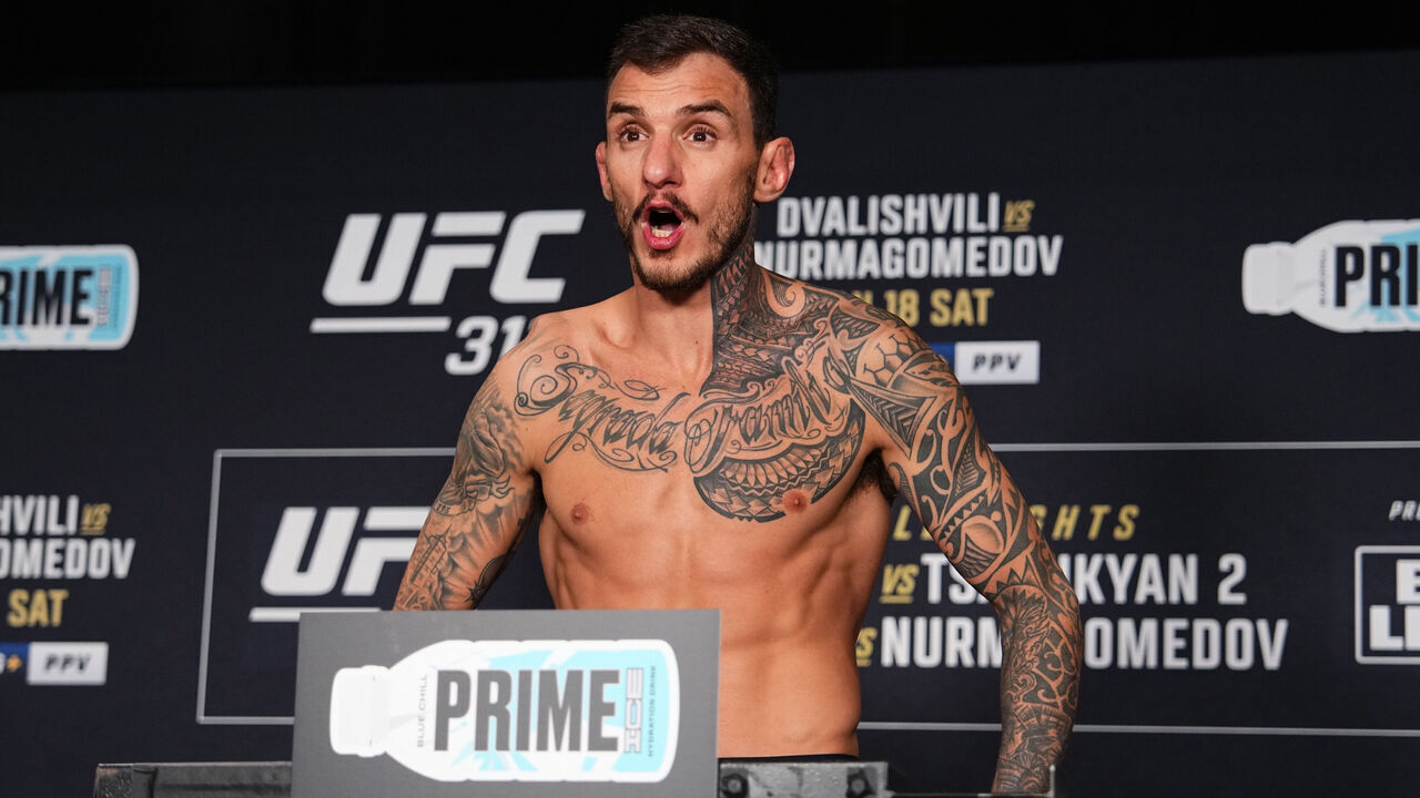 LOS ANGELES, CALIFORNIA - JANUARY 17: Renato Moicano of Brazil poses on the scale during the UFC 311 official weigh-in at the InterContinental Los Angeles Downtown on January 17, 2025 in Los Angeles, California.