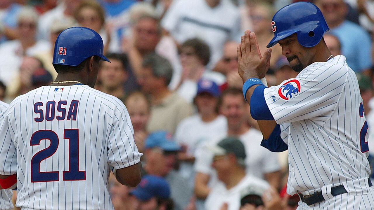 CHICAGO - AUGUST 26: Sammy Sosa #21 of the Chicago Cubs is greeted by teammates Nomar Garciaparra #5 (L) and Derrek Lee #25 after hitting a three-run home run in the third inning against the Houston Astros on August 26, 2004 at Wrigley Field in Chicago, Illinois. The Cubs defeated the Astros 8-3.