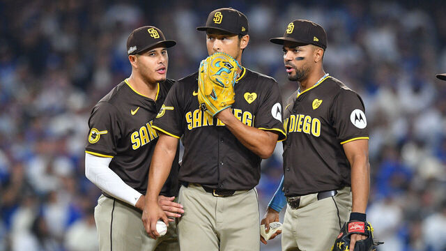 LOS ANGELES, CA - OCTOBER 06: San Diego Padres third baseman Manny Machado (13) and San Diego Padres shortstop Xander Bogaerts (2) talk with San Diego Padres pitcher Yu Darvish (11) during game two of the National League Division Series game between the San Diego Padres and the Los Angeles Dodgers on October 6, 2024 at Dodger Stadium in Los Angeles, CA.