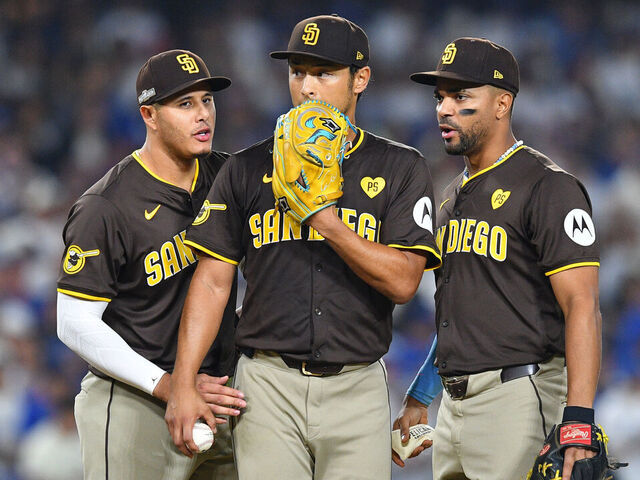 LOS ANGELES, CA - OCTOBER 06: San Diego Padres third baseman Manny Machado (13) and San Diego Padres shortstop Xander Bogaerts (2) talk with San Diego Padres pitcher Yu Darvish (11) during game two of the National League Division Series game between the San Diego Padres and the Los Angeles Dodgers on October 6, 2024 at Dodger Stadium in Los Angeles, CA.