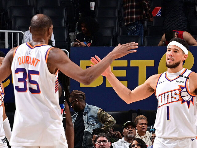 DETROIT, MI - JANUARY 18: Kevin Durant #35 and Devin Booker #1 of the Phoenix Suns high five during the game against the Detroit Pistons on January 18, 2025 at Little Caesars Arena in Detroit, Michigan. NOTE TO USER: User expressly acknowledges and agrees that, by downloading and/or using this photograph, User is consenting to the terms and conditions of the Getty Images License Agreement. Mandatory Copyright Notice: Copyright 2025 NBAE