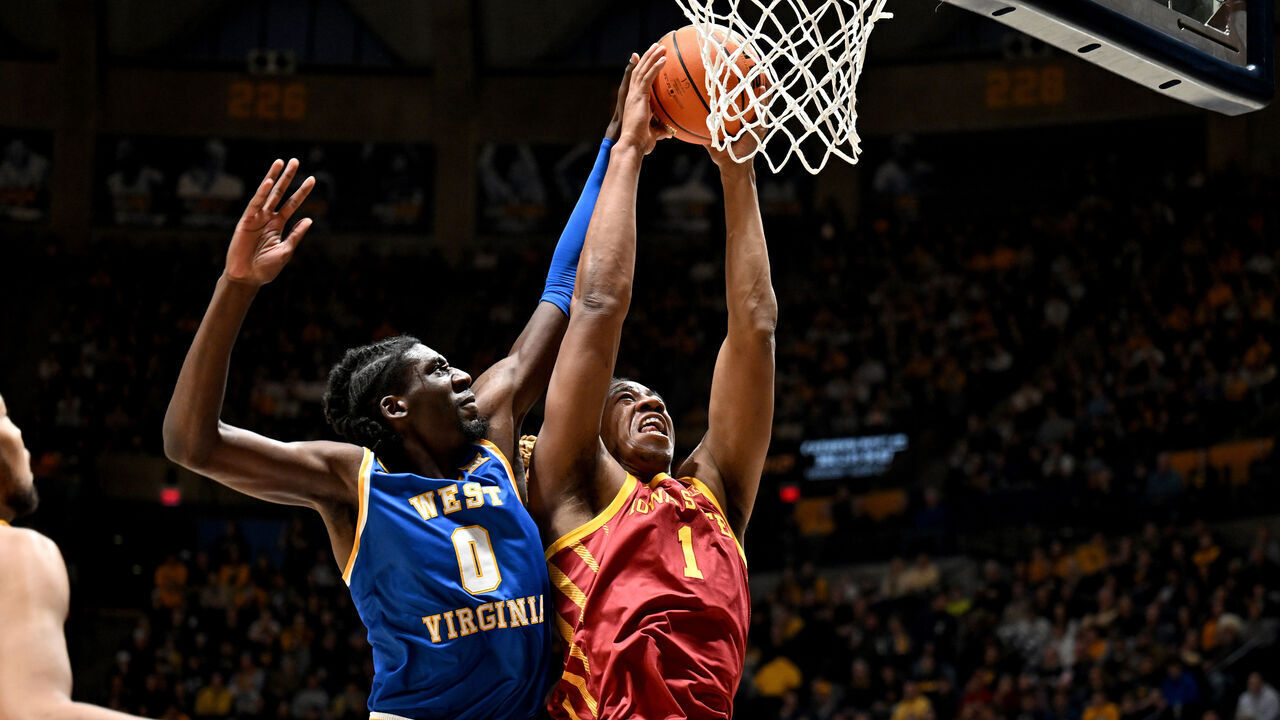 MORGANTOWN, WEST VIRGINIA - JANUARY 18: Dishon Jackson #1 of the Iowa State Cyclones drives to the basket against Eduardo Andre #0 of the West Virginia Mountaineers in the first half at WVU Coliseum on January 18, 2025 in Morgantown, West Virginia.