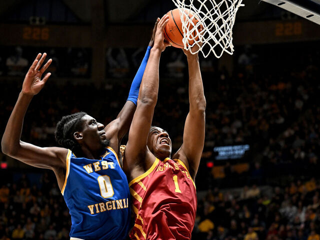 MORGANTOWN, WEST VIRGINIA - JANUARY 18: Dishon Jackson #1 of the Iowa State Cyclones drives to the basket against Eduardo Andre #0 of the West Virginia Mountaineers in the first half at WVU Coliseum on January 18, 2025 in Morgantown, West Virginia.