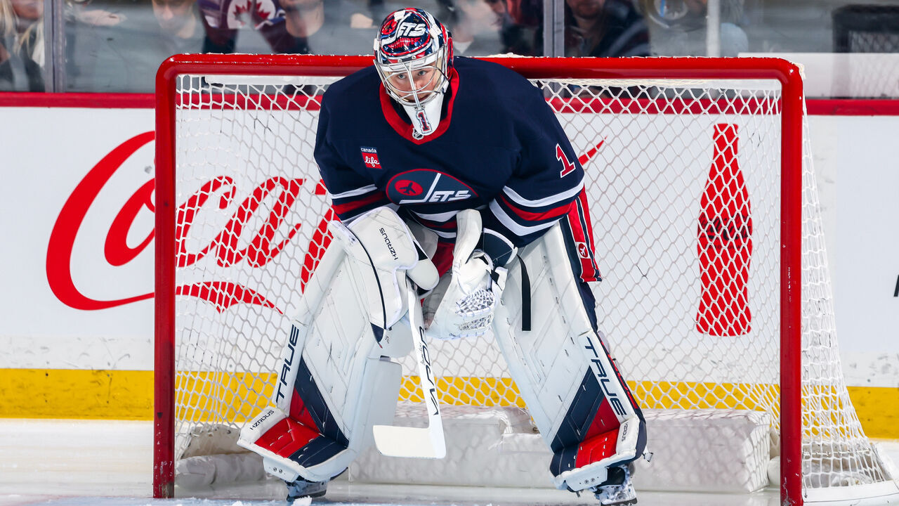 WINNIPEG, CANADA - JANUARY 18: Goaltender Eric Comrie #1 of the Winnipeg Jets looks on from the crease prior to puck drop against the Calgary Flames at the Canada Life Centre on January 18, 2025 in Winnipeg, Manitoba, Canada.