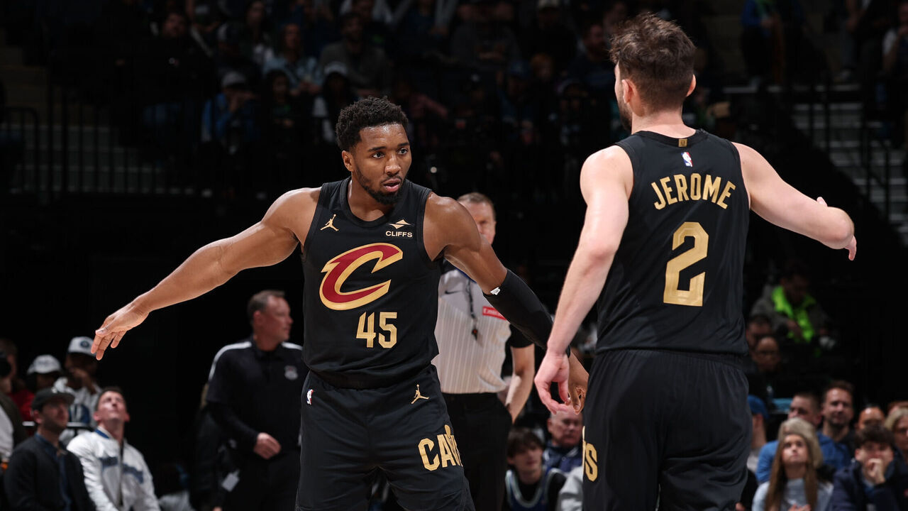 MINNEAPOLIS, MN - JANUARY 18: Donovan Mitchell #45 and Ty Jerome #2 of the Cleveland Cavaliers high five during the game against the Minnesota Timberwolves on January 18, 2025 at Target Center in Minneapolis, Minnesota. Mandatory Copyright Notice: Copyright 2025 NBAE