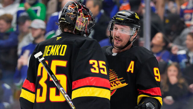VANCOUVER, CANADA - JANUARY 18: J.T. Miller #9 and Thatcher Demko #35 of the Vancouver Canucks talk during the third period of their NHL game against the Edmonton Oilers at Rogers Arena on January 18, 2025 in Vancouver, British Columbia, Canada.
