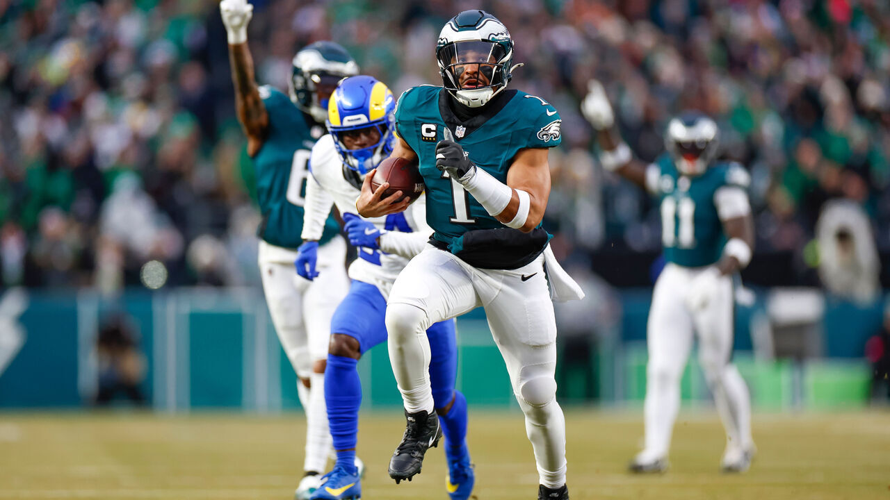 PHILADELPHIA, PENNSYLVANIA - JANUARY 19: Jalen Hurts #1 of the Philadelphia Eagles runs with the ball for a touchdown in the first quarter during the NFC Divisional Playoff game against the Los Angeles Rams at Lincoln Financial Field on January 19, 2025 in Philadelphia, Pennsylvania.