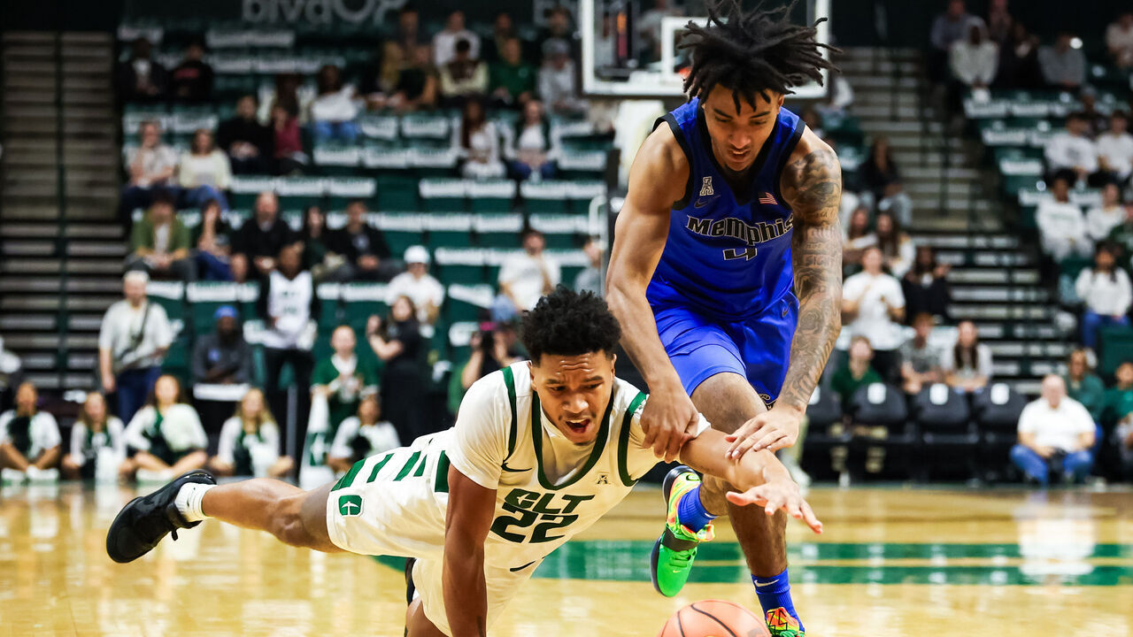 CHARLOTTE, NORTH CAROLINA - JANUARY 19: Jaehshon Thomas #22 of the Charlotte 49ers and PJ Haggerty #4 of the Memphis Tigers fight for a loose ball during the first half of a basketball game at Dale F. Halton Arena on January 19, 2025 in Charlotte, North Carolina.
