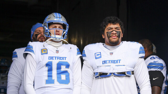 CHICAGO, ILLINOIS - DECEMBER 22: Jared Goff #16 and Penei Sewell #58 of the Detroit Lions wait in the tunnel before the game against the Chicago Bears at Soldier Field on December 22, 2024 in Chicago, Illinois.