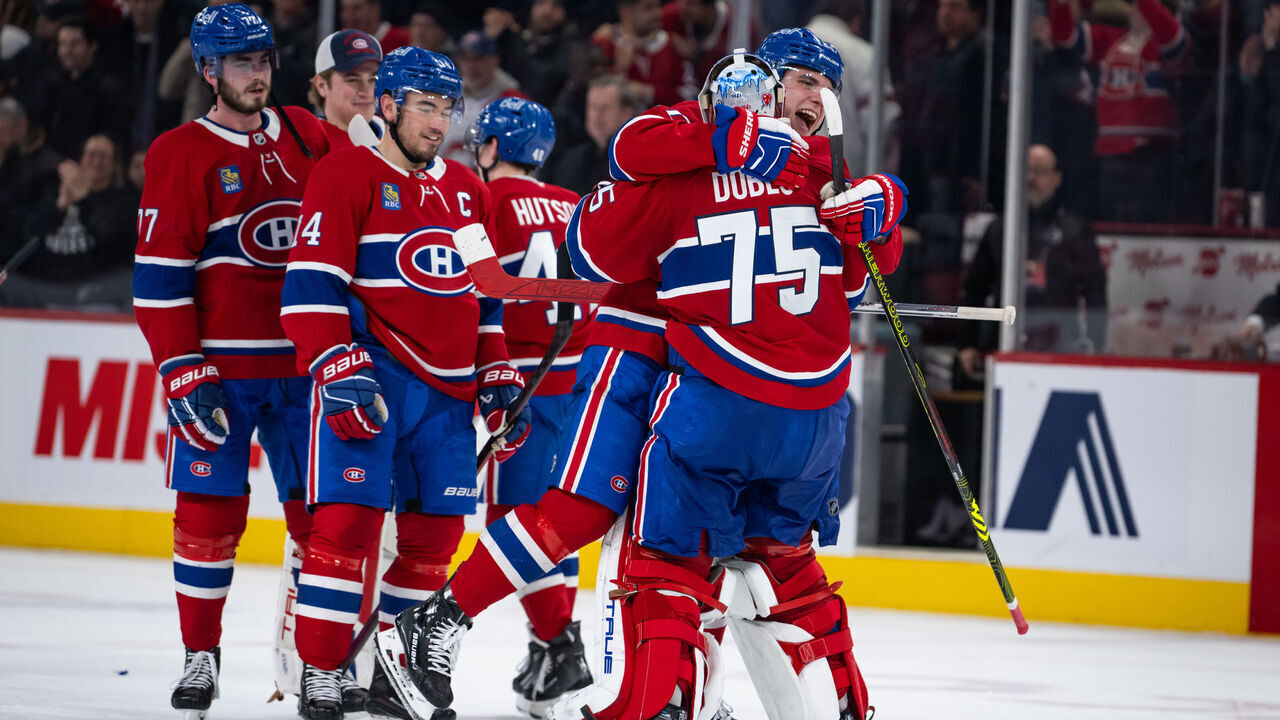 MONTREAL, QC - JANUARY 19: Juraj Slafkovsky (20) of the Montreal Canadiens hugs teammate Jakub Dobes (75) after winning the NHL game between the New York Rangers and the Montreal Canadiens on Jan 19 2025, at the Bell Centre in Montreal, QC