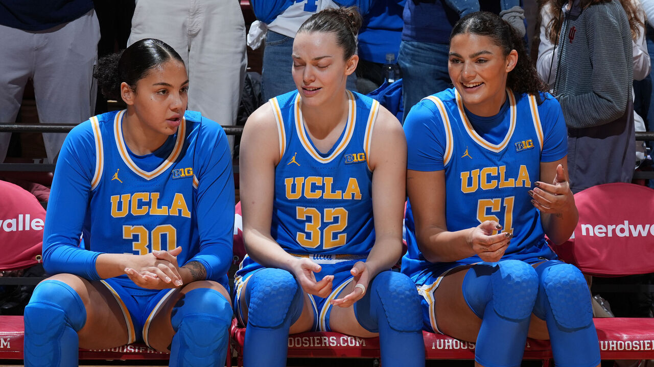 BLOOMINGTON, IN - JANUARY 04: From left to right UCLA Bruins forward Timea Gardiner (30) and forward Angela Dugalic'(32) and center Lauren Betts (51) wait to be introduced before the game against the Indiana Hoosiers on January 4, 2025, at Simon Skjodt Assembly Hall in Bloomington, Indiana.
