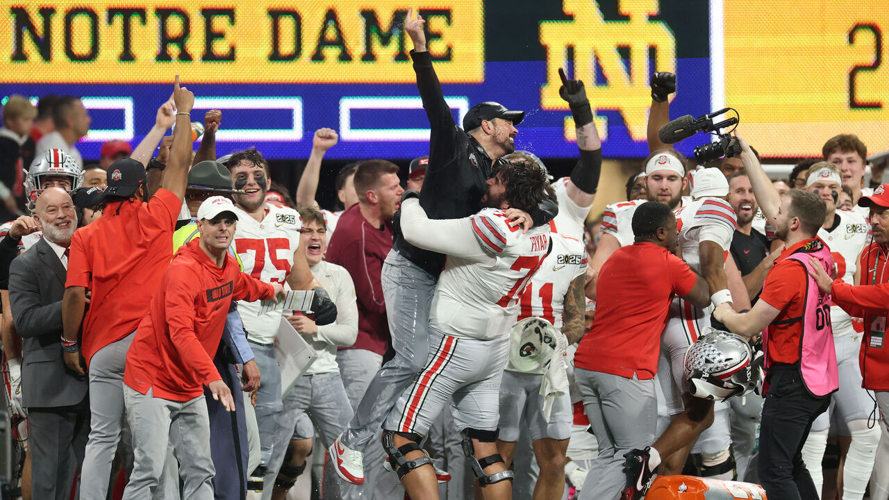ATLANTA, GEORGIA - JANUARY 20: Josh Fryar #70 and head coach Ryan Day of the Ohio State Buckeyes celebrate after beating the Notre Dame Fighting Irish 34-23 in the 2025 CFP National Championship at the Mercedes-Benz Stadium on January 20, 2025 in Atlanta, Georgia.