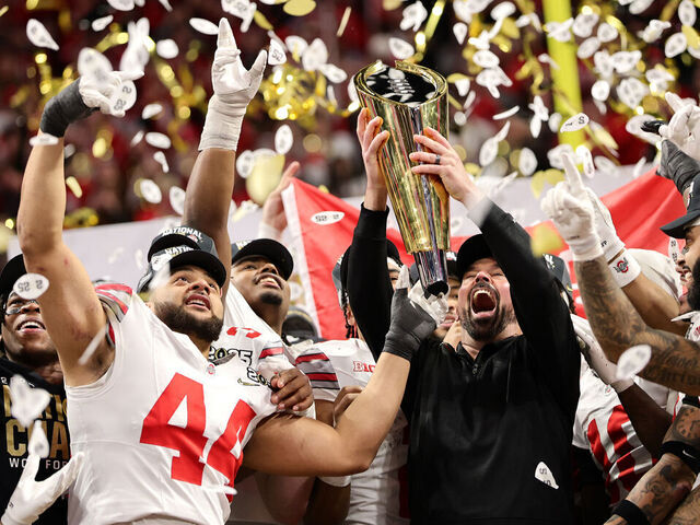 ATLANTA, GEORGIA - JANUARY 20: Head coach Ryan Day and the Ohio State Buckeyes hoist the trophy after beating the Notre Dame Fighting Irish 34-23 in the 2025 CFP National Championship at the Mercedes-Benz Stadium on January 20, 2025 in Atlanta, Georgia.
