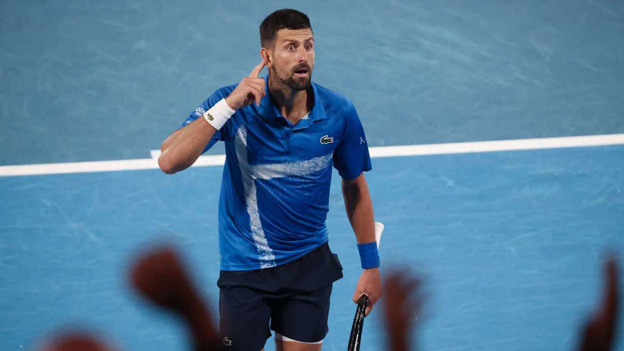 Serbia's Novak Djokovic gestures to the crowd after winning the third set during his men's singles quarterfinal match against Spain's Carlos Alcaraz on day ten of the Australian Open tennis tournament in Melbourne on January 21, 2025.