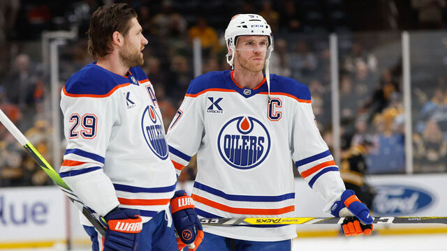 BOSTON, MASSACHUSETTS - JANUARY 7: Connor McDavid #97 and Leon Draisaitl #29 both of the Edmonton Oilers look on during warm-up before a game against the Boston Bruins at the TD Garden on January 7, 2025 in Boston, Massachusetts.