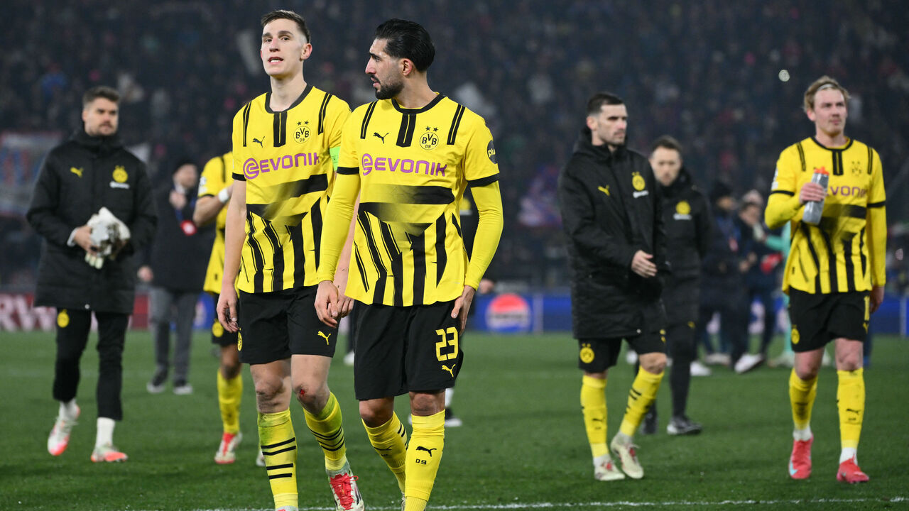 Dortmund's German defender #04 Nico Schlotterbeck (L) and Dortmund's German midfielder #23 Emre Can look dejected after being defeated in the UEFA Champions League football match between Bologna and Borussia Dortmund at the Renato Dall'Ara stadium in Bologna on January 21, 2025.