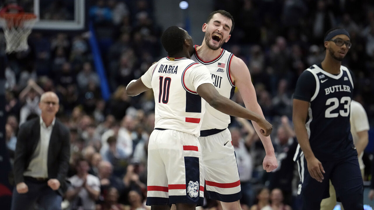 HARTFORD, CONNECTICUT - JANUARY 21: Hassan Diarra #10 and Alex Karaban #11 of the Connecticut Huskies react during the first half of an NCAA basketball game against the Butler Bulldogs at the XL Center on January 21, 2025 in Hartford, Connecticut.