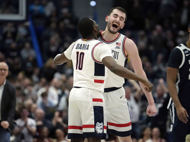 HARTFORD, CONNECTICUT - JANUARY 21: Hassan Diarra #10 and Alex Karaban #11 of the Connecticut Huskies react during the first half of an NCAA basketball game against the Butler Bulldogs at the XL Center on January 21, 2025 in Hartford, Connecticut.