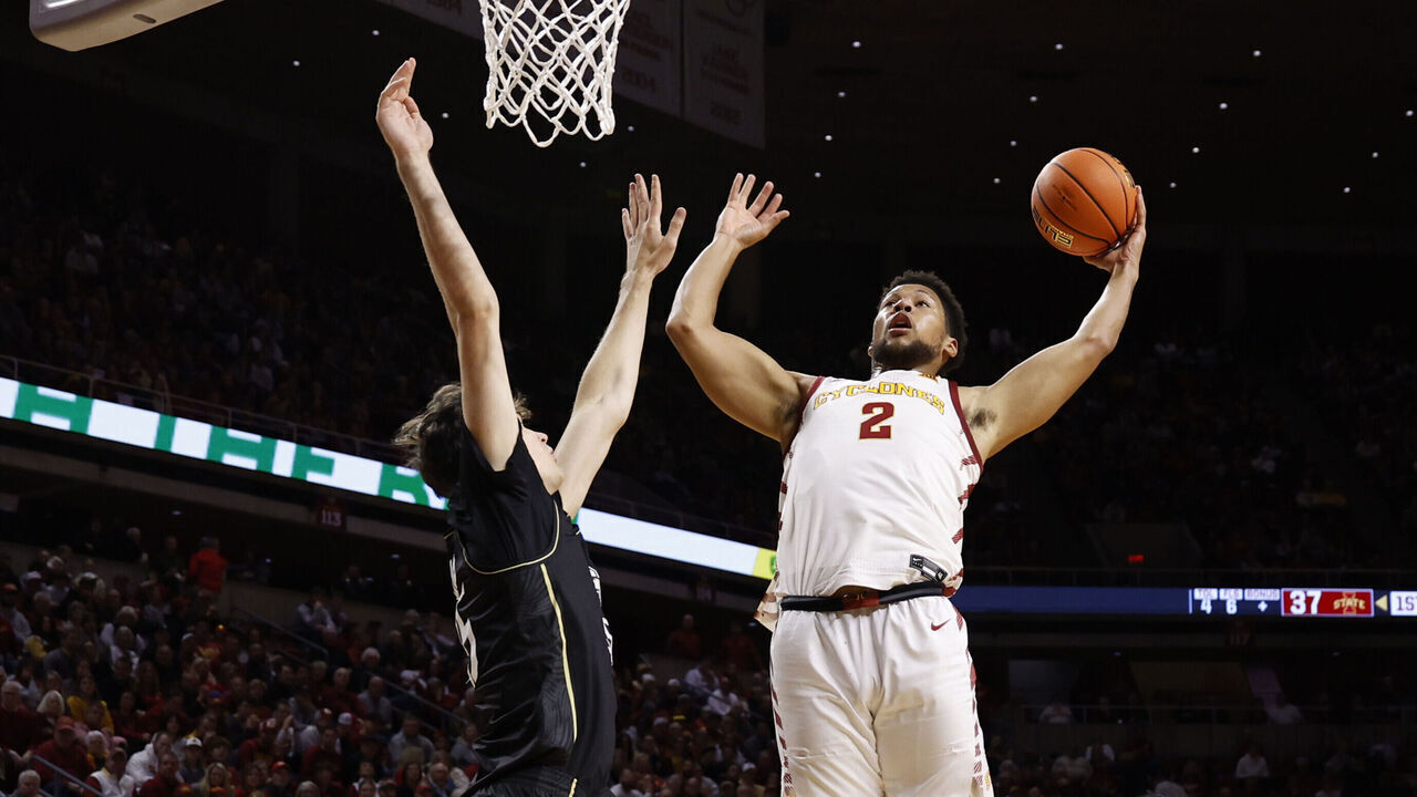 AMES, IA - JANUARY 21: Joshua Jefferson #2 of the Iowa State Cyclones takes a shot as Rokas Jocius #35 of the UCF Knights blocks as Demarion Watson #4 of the Iowa State Cyclones watches on in the first half of play at Hilton Coliseum on January 21, 2025, in Ames, Iowa.