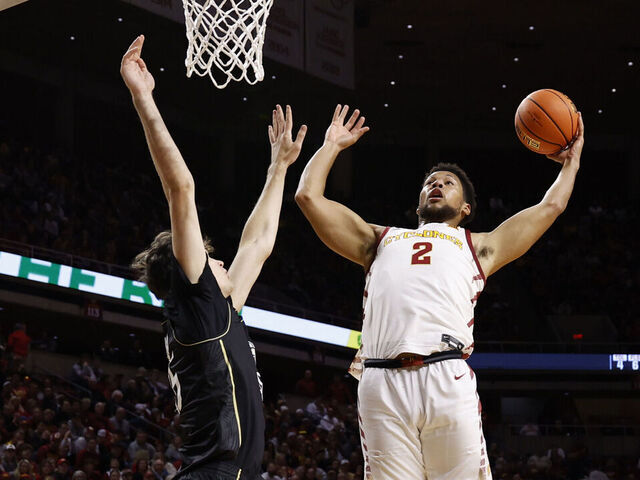 AMES, IA - JANUARY 21: Joshua Jefferson #2 of the Iowa State Cyclones takes a shot as Rokas Jocius #35 of the UCF Knights blocks as Demarion Watson #4 of the Iowa State Cyclones watches on in the first half of play at Hilton Coliseum on January 21, 2025, in Ames, Iowa.