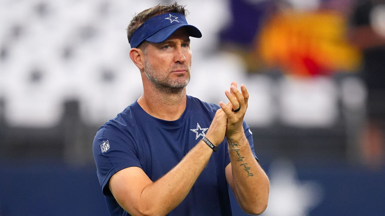 ARLINGTON, TEXAS - SEPTEMBER 22: Dallas Cowboys offensive coordinator Brian Schottenheimer watches his team warm up before the game against the Baltimore Ravens at AT&T Stadium on September 22, 2024 in Arlington, Texas.
