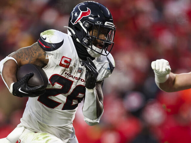 KANSAS CITY, MISSOURI - JANUARY 18: Joe Mixon #28 of the Houston Texans runs the ball during an NFL football AFC divisional playoff game against the Kansas City Chiefs at GEHA Field at Arrowhead Stadium on January 18, 2025 in Kansas City, Missouri.