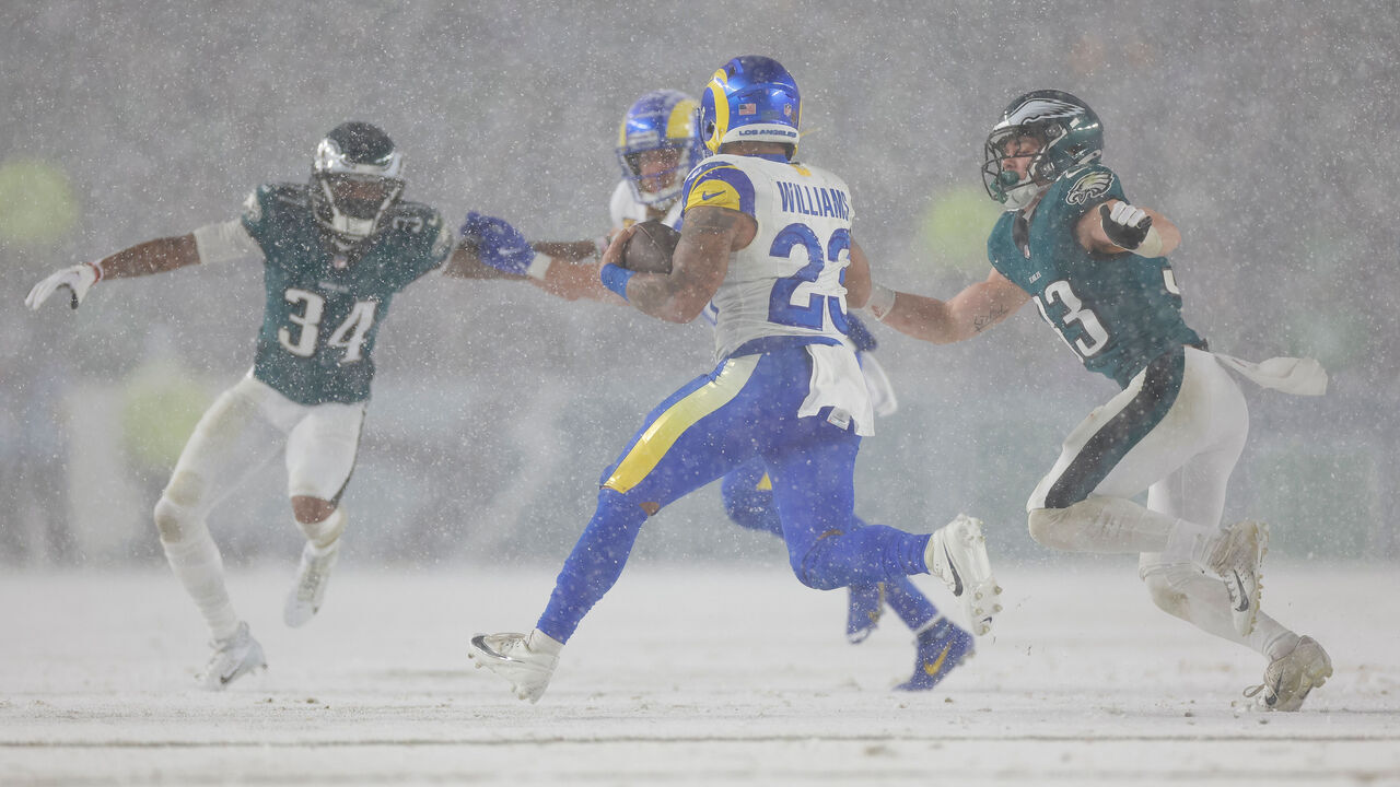 PHILADELPHIA, PENNSYLVANIA - JANUARY 19: Kyren Williams #23 of the Los Angeles Rams carries the ball in front of Cooper DeJean #33 of the Philadelphia Eagles during the second half of the NFC Divisional Playoff game at Lincoln Financial Field on January 19, 2025 in Philadelphia, Pennsylvania.