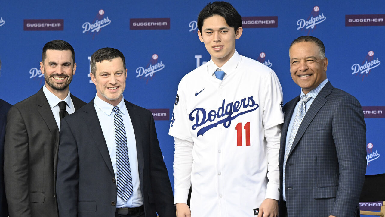 Los Angeles, CA - January 22: Japanese pitcher Roki Sasaki with Andrew Friedman, president of baseball operations along with general manager Brandon Gomes, left, and manager Dave Roberts as he is introduced as the newest Dodger during a press conference at Dodger Stadium in Los Angeles on Wednesday, January 22, 2025.