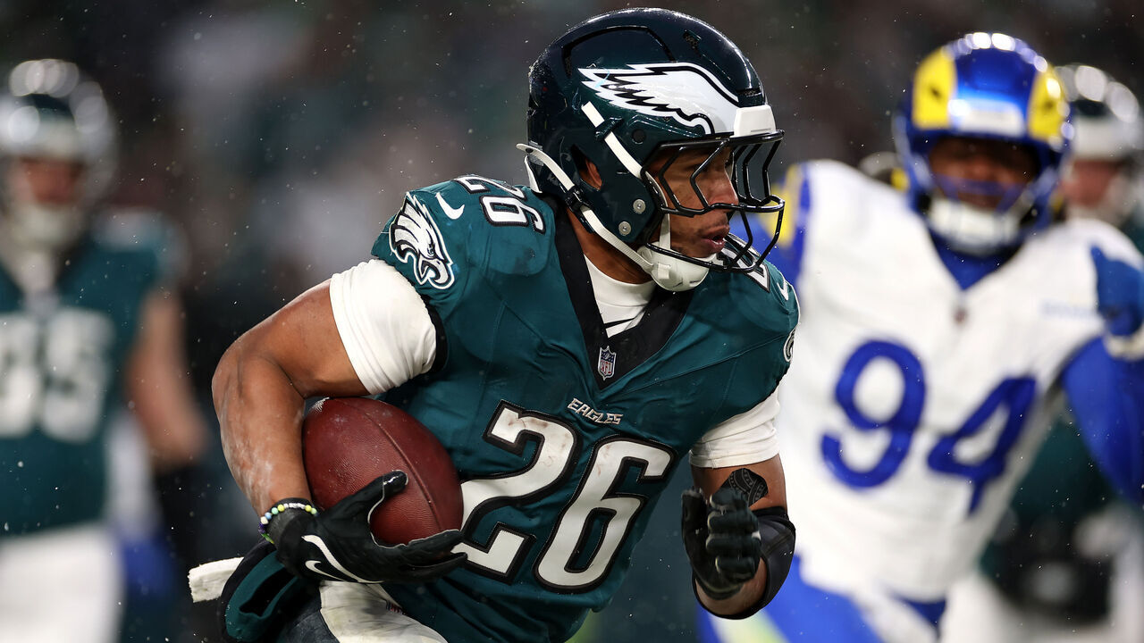 PHILADELPHIA, PENNSYLVANIA - JANUARY 19: Saquon Barkley #26 of the Philadelphia Eagles runs the ball against the Los Angeles Rams during the second quarter in the NFC Divisional Playoff at Lincoln Financial Field on January 19, 2025 in Philadelphia, Pennsylvania.
