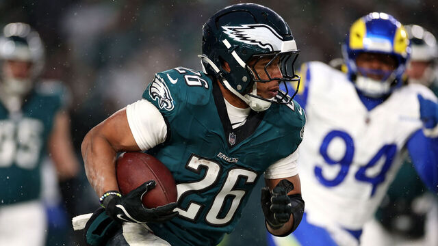PHILADELPHIA, PENNSYLVANIA - JANUARY 19: Saquon Barkley #26 of the Philadelphia Eagles runs the ball against the Los Angeles Rams during the second quarter in the NFC Divisional Playoff at Lincoln Financial Field on January 19, 2025 in Philadelphia, Pennsylvania.