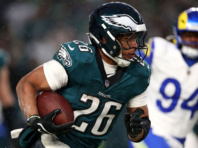 PHILADELPHIA, PENNSYLVANIA - JANUARY 19: Saquon Barkley #26 of the Philadelphia Eagles runs the ball against the Los Angeles Rams during the second quarter in the NFC Divisional Playoff at Lincoln Financial Field on January 19, 2025 in Philadelphia, Pennsylvania.