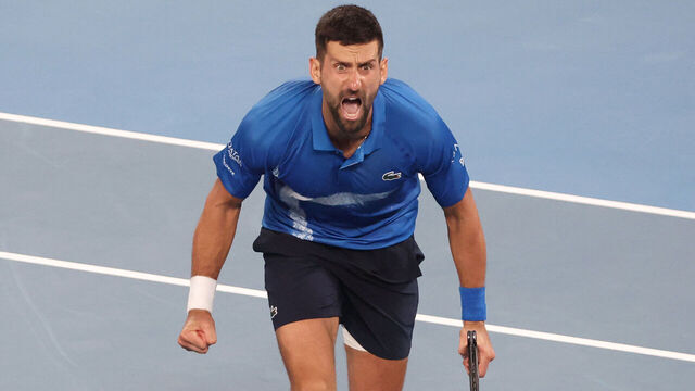 Serbia's Novak Djokovic celebrates after his victory against Spain's Carlos Alcaraz in their men's singles quarterfinal match on day ten of the Australian Open tennis tournament in Melbourne early on January 22, 2025.