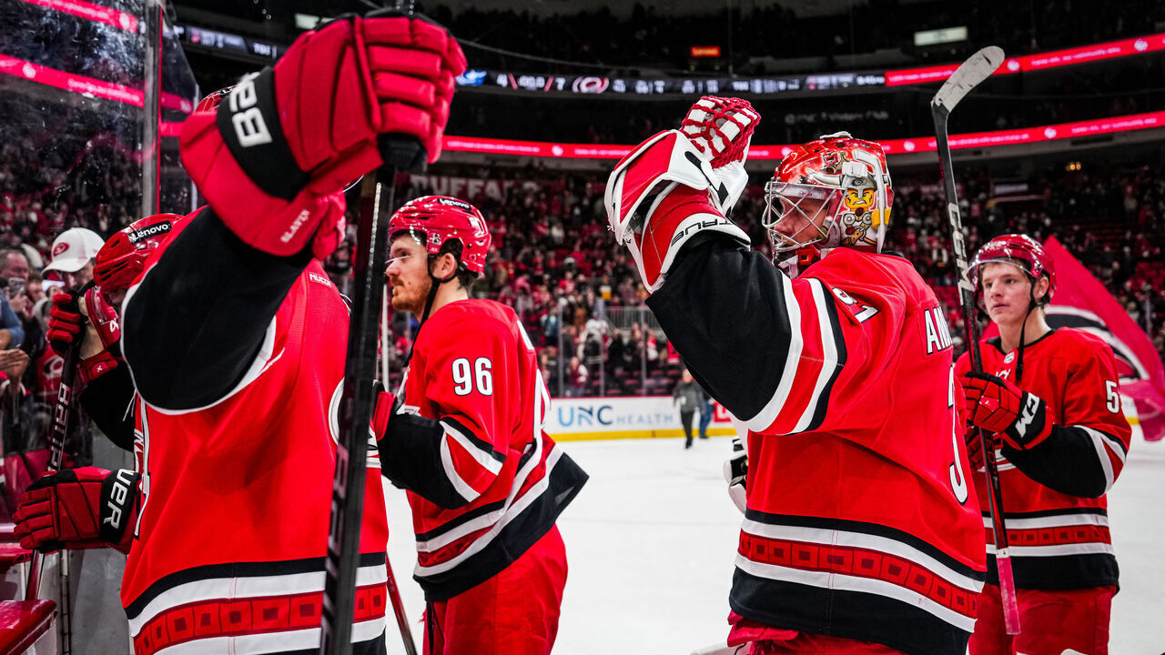 RALEIGH, NORTH CAROLINA - JANUARY 23: Frederik Andersen #31 of the Carolina Hurricanes celebrates with teammates after a 7-4 victory against the Columbus Blue Jackets to record his 300th career victory at Lenovo Center on January 23, 2025 in Raleigh, North Carolina.