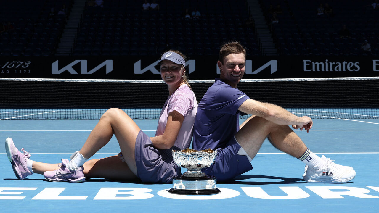 Australia's Olivia Gadecki (L) and John Peers celebrate with the trophy after their victory against Australia's Kimberly Birrell and John-Patrick Smith in their mixed doubles final match on day thirteen of the Australian Open tennis tournament in Melbourne on January 24, 2025.