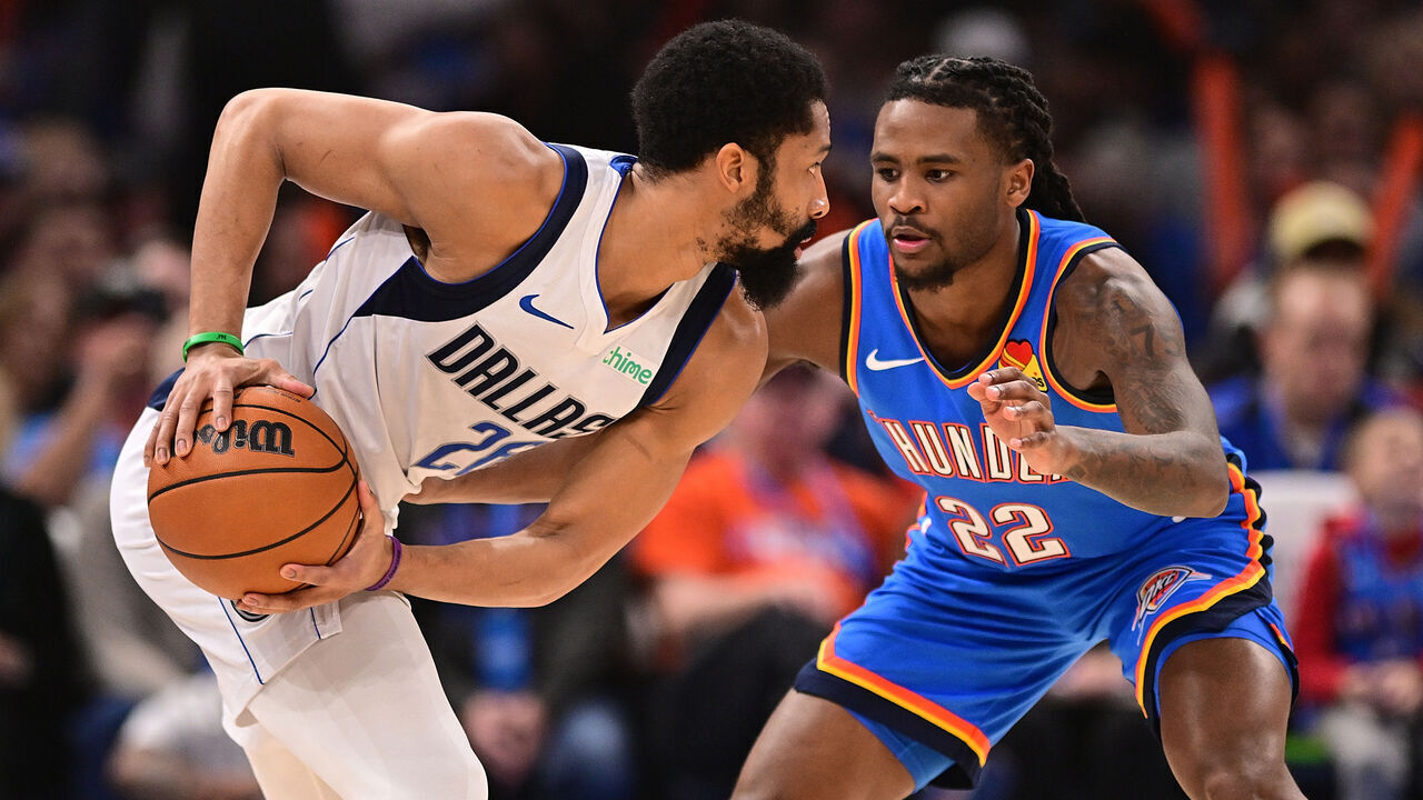 OKLAHOMA CITY, OKLAHOMA - JANUARY 23: Spencer Dinwiddie #26 of the Dallas Mavericks looks to make a move while being defended by Cason Wallace #22 of the Oklahoma City Thunder during the first half at Paycom Center on January 23, 2025 in Oklahoma City, Oklahoma.