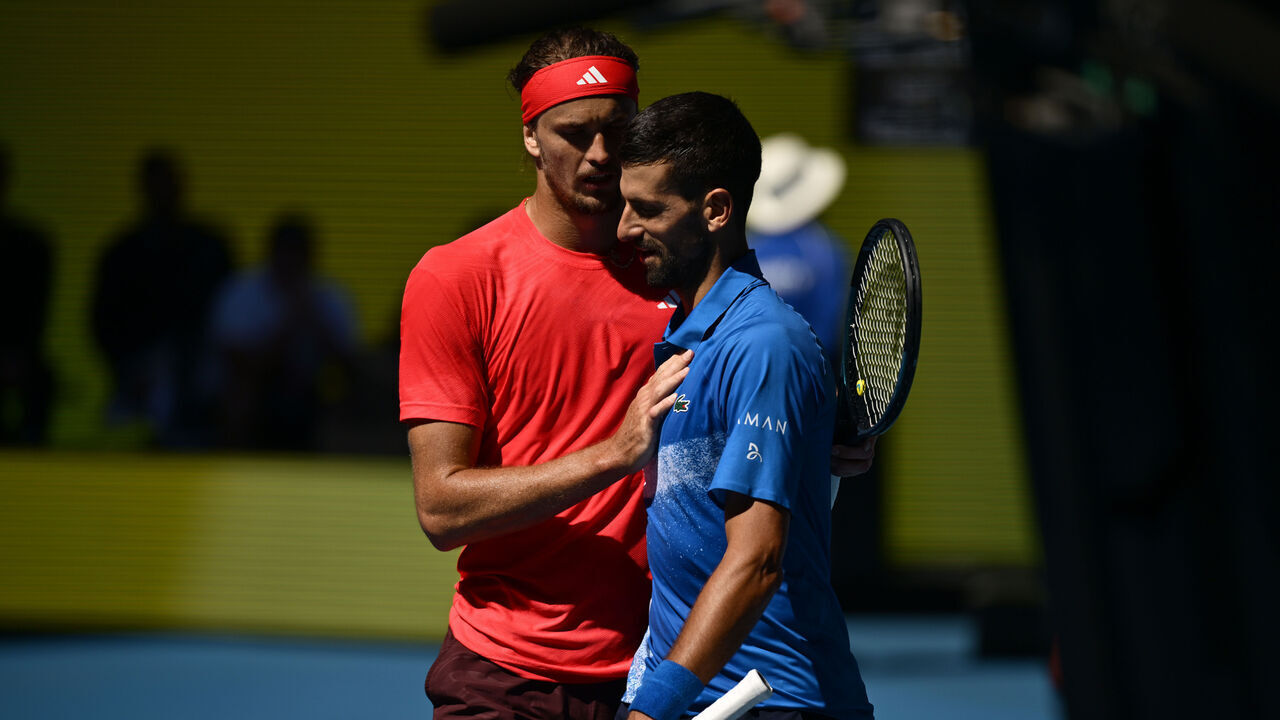 MELBOURNE, AUSTRALIA - JANUARY 24: Novak Djokovic of Serbia is embraced by Alexander Zverev of Germany after retiring from the Men's Singles Semifinal during day 13 of the 2025 Australian Open at Melbourne Park on January 24, 2025 in Melbourne, Australia.