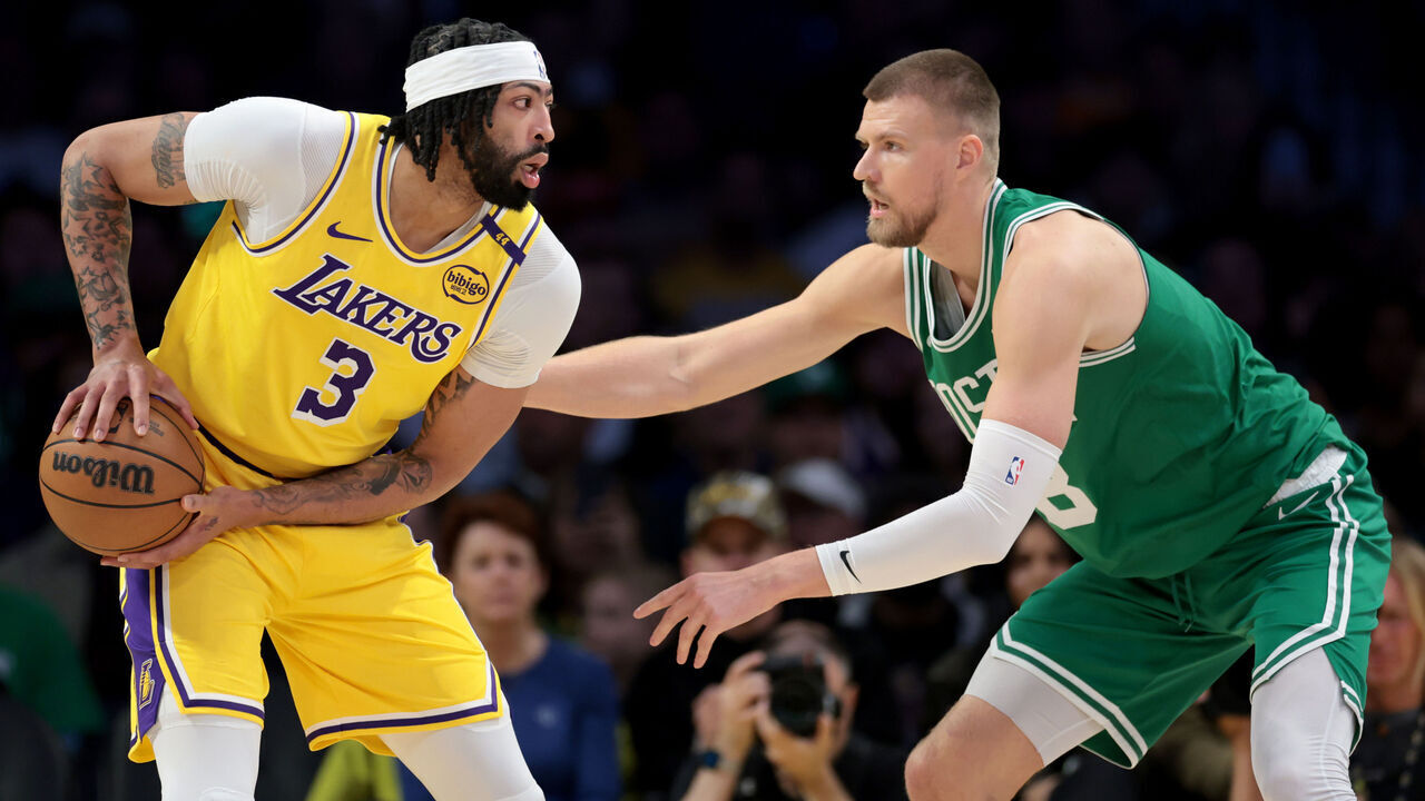 LOS ANGELES, CALIFORNIA - JANUARY 23: Anthony Davis #3 of the Los Angeles Lakers is guarded by Kristaps Porzingis #8 of the Boston Celtics during a 117-96 Lakers win at Crypto.com Arena on January 23, 2025 in Los Angeles, California.