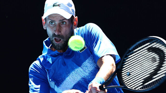 Serbia's Novak Djokovic hits a return against Germany's Alexander Zverev during their men's singles semi-final match on day thirteen of the Australian Open tennis tournament in Melbourne on January 24, 2025.