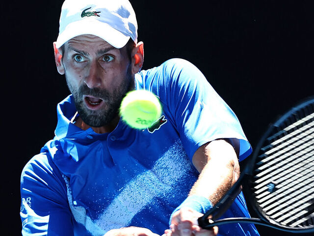 Serbia's Novak Djokovic hits a return against Germany's Alexander Zverev during their men's singles semi-final match on day thirteen of the Australian Open tennis tournament in Melbourne on January 24, 2025.