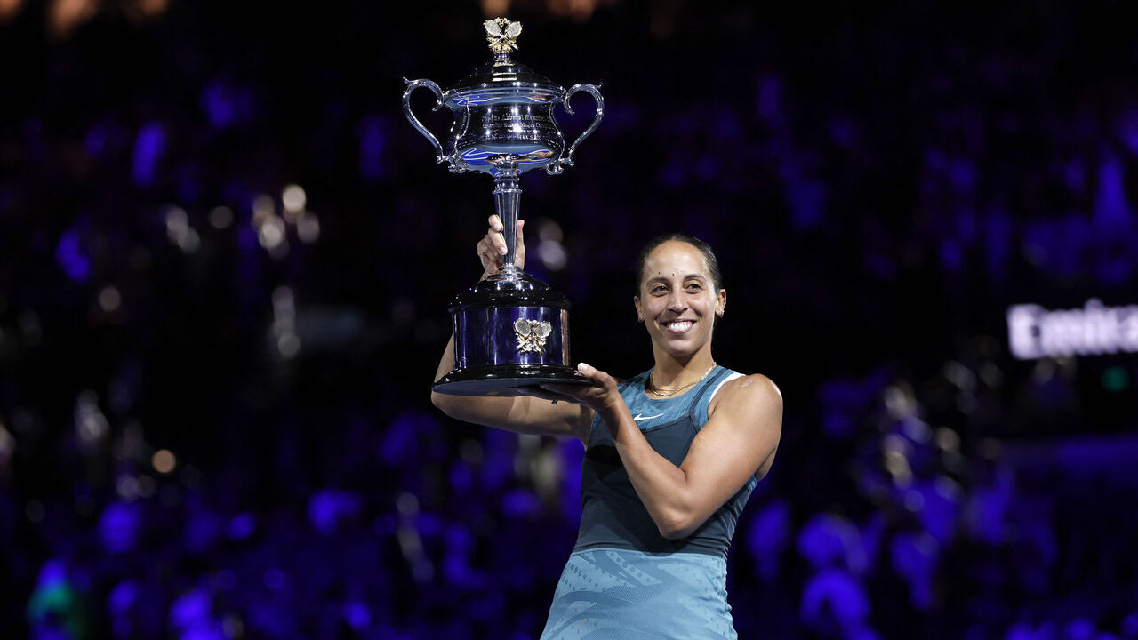 USA's Madison Keys celebrates with the Daphne Akhurst Memorial Cup after defeating Belarus' Aryna Sabalenka during their women's singles final match on day fourteen of the Australian Open tennis tournament in Melbourne on January 25, 2025.