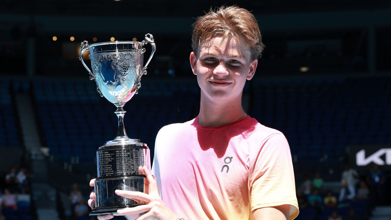 MELBOURNE, AUSTRALIA - JANUARY 25: Henry Bernet of Switzerland holds aloft the championship trophy after winning the Junior Boys' Singles Final against Benjamin Willwerth of the United States during day 14 of the 2025 Australian Open at Melbourne Park on January 25, 2025 in Melbourne, Australia.