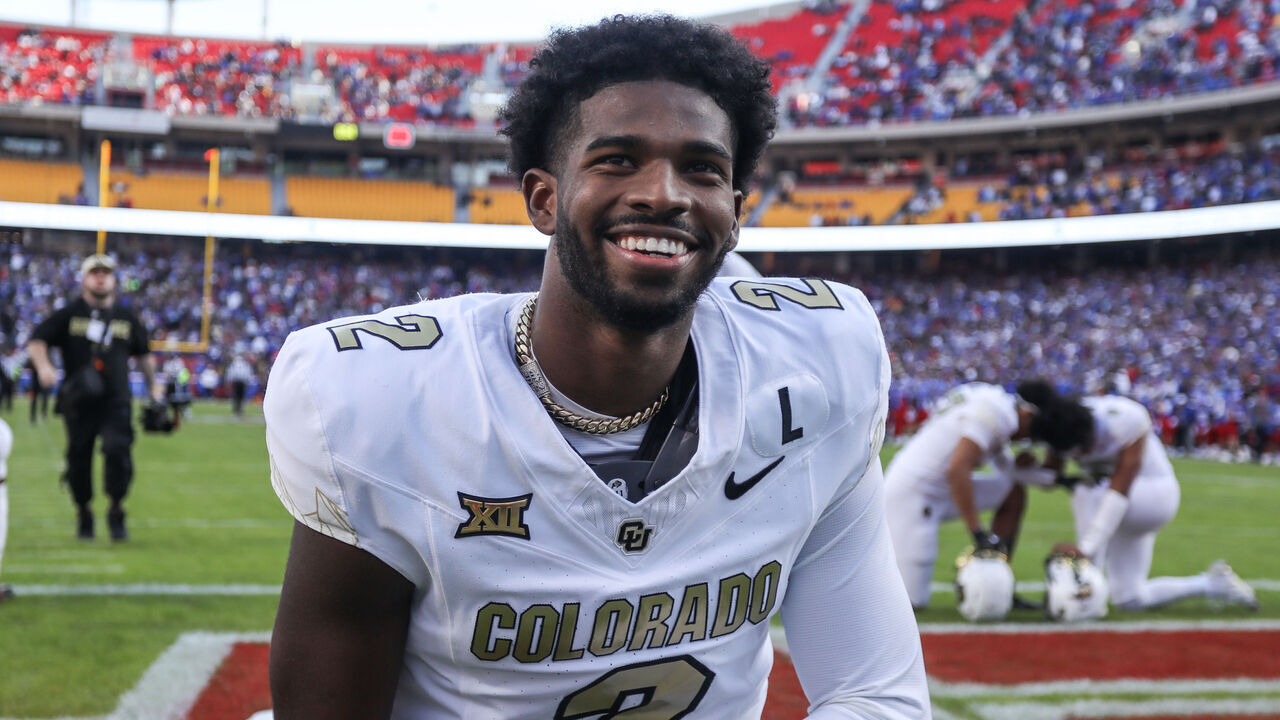 KANSAS CITY, MO - NOVEMBER 23: Colorado Buffaloes quarterback Shedeur Sanders (2) kneels and smiles before a Big 12 game between the Colorado Buffaloes and Kansas Jayhawks on November 23, 2024 at GEHA Field at Arrowhead Stadium in Kansas City, MO.