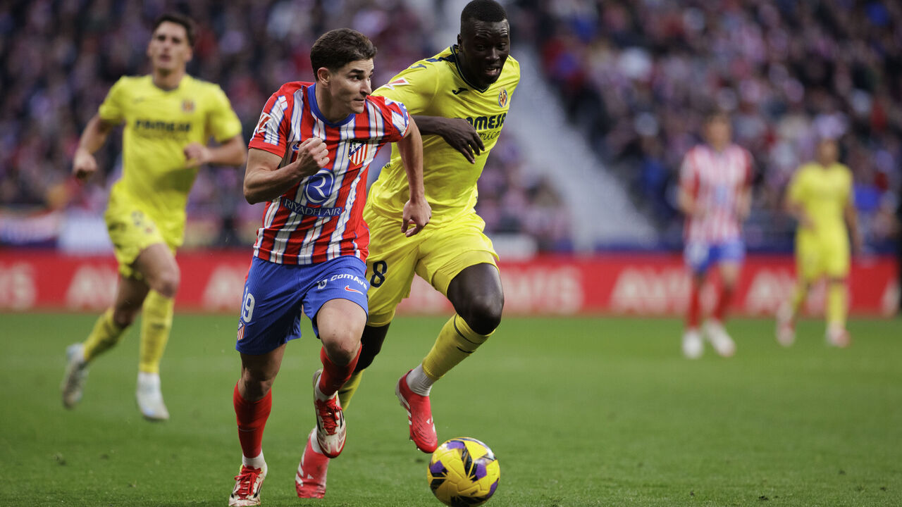 Julian Alvarez of Atletico de Madrid and Pape Gueye of Villarreal fight for the ball during the La Liga 2024/25 match between Atletico de Madrid and Villarreal at Riyadh Air Metropolitano Stadium in Madrid, Spain, on January 25.