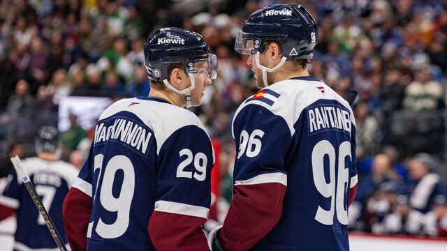 DENVER, COLORADO - JANUARY 20: (L-R) Nathan MacKinnon #29 and Mikko Rantanen #96 of the Colorado Avalanche talk during a pause in the game against the Minnesota Wildat Ball Arena on January 20, 2025 in Denver, Colorado.