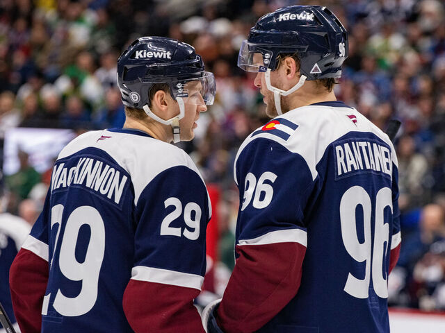 DENVER, COLORADO - JANUARY 20: (L-R) Nathan MacKinnon #29 and Mikko Rantanen #96 of the Colorado Avalanche talk during a pause in the game against the Minnesota Wildat Ball Arena on January 20, 2025 in Denver, Colorado.