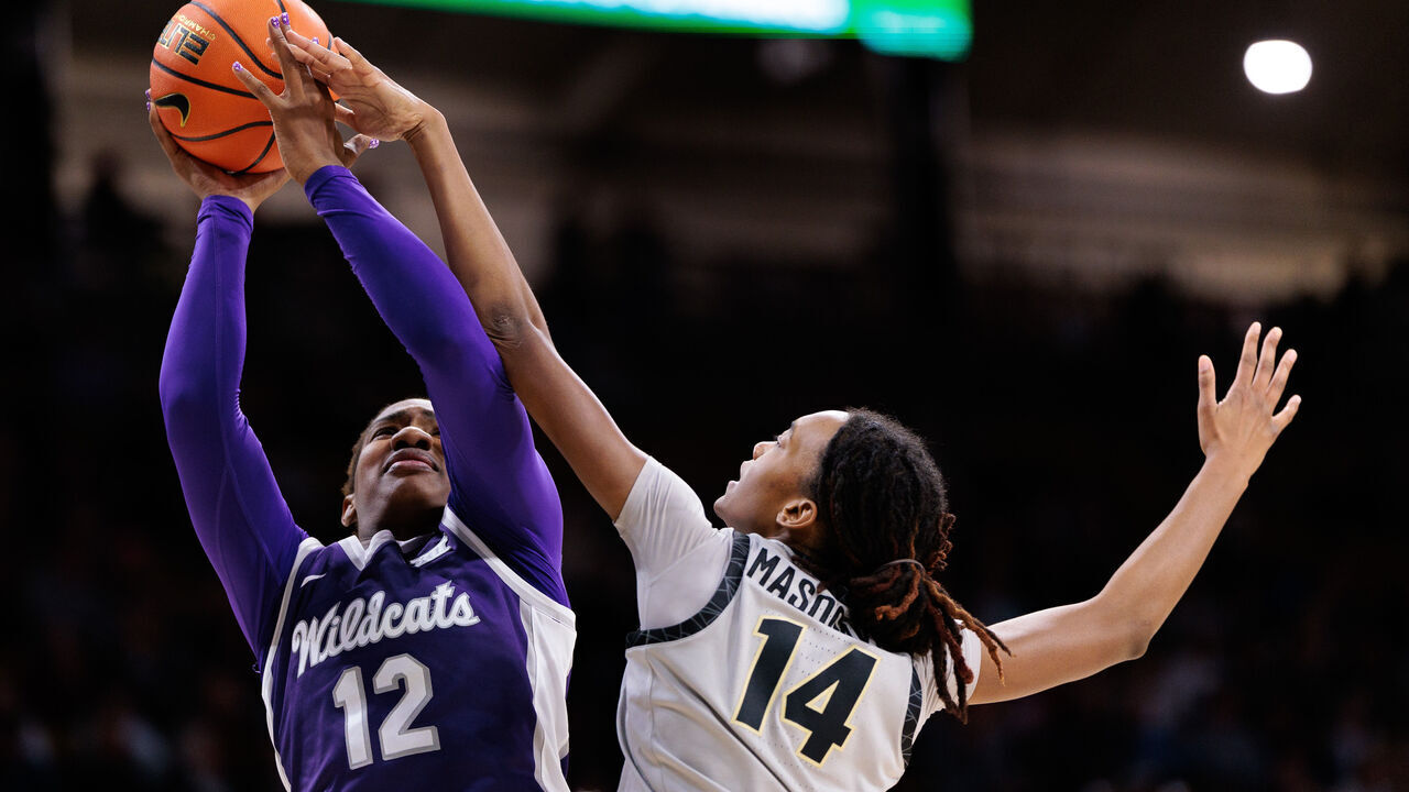 BOULDER, COLORADO - JANUARY 25: Kennedy Taylor #12 of the Kansas State Wildcats shoots the ball against Jade Masogayo #14 of the Colorado Buffaloes during the fourth quarter at the CU Events Center on January 25, 2025 in Boulder, Colorado.