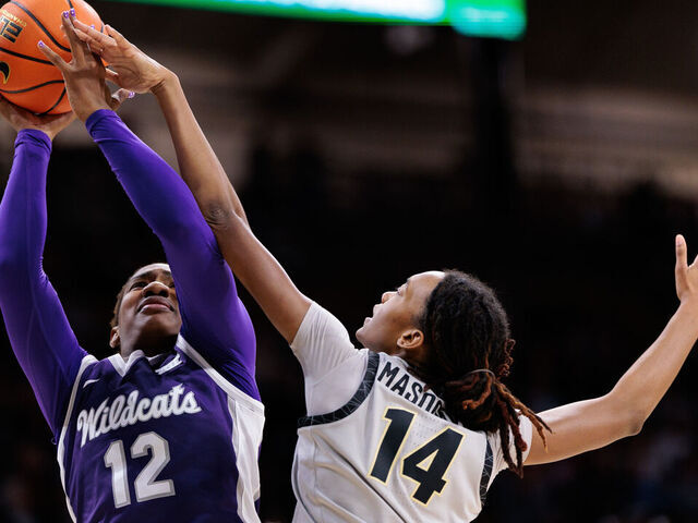 BOULDER, COLORADO - JANUARY 25: Kennedy Taylor #12 of the Kansas State Wildcats shoots the ball against Jade Masogayo #14 of the Colorado Buffaloes during the fourth quarter at the CU Events Center on January 25, 2025 in Boulder, Colorado.